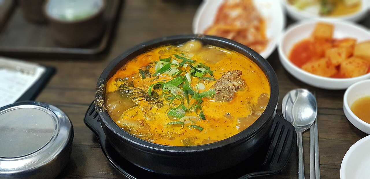 Single serving of Korean ppyeo-haejangguk pork-bone soup in an earthenware bowl