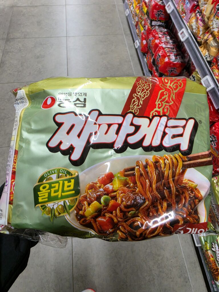 A multipack of Nongshim Chapagetti instant black bean noodles with the Korean name 짜파게티 printed on the green package