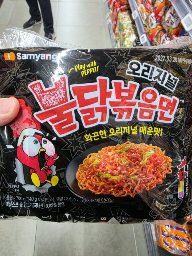 A multipack of Samyang Buldak Bokkeummyeon spicy instant noodles with the Korean text 불닭볶음면 on a black package